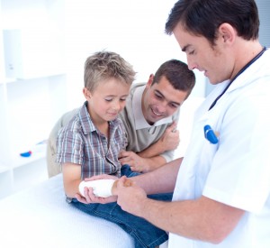 Doctor inspects boys arm at Torrance Urgent Care